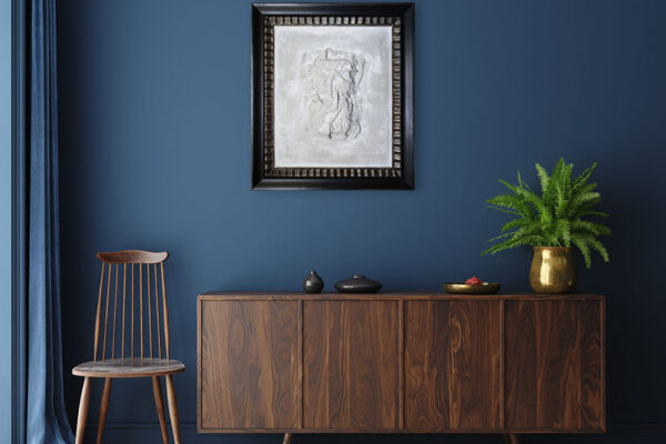 Commode with chair and decor in living room interior, dark blue wall mock up background, 3D render